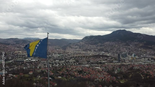 Flag of Bosnia and Herzegovina Flying Above the Capital Sarajevo Aerial Shot 4K