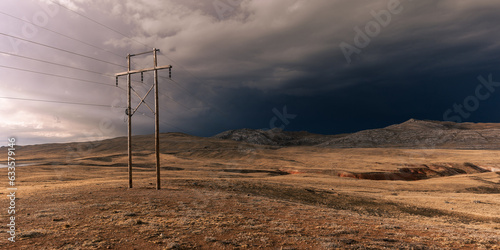 Minor power lines cross the high Andean plains photo