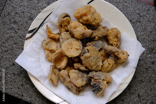 fried portabello mushrooms on a plate. vegan food. meat substitute. Asian food. Indonesian food.  photo