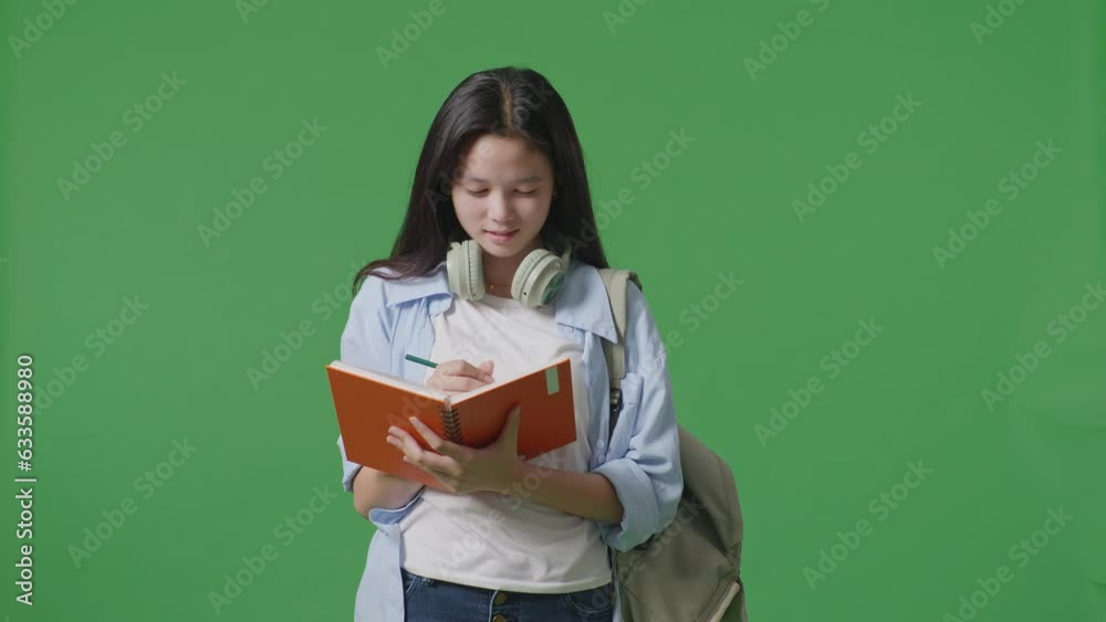 Asian Teen Girl Student With A Backpack Smiling And Taking Note On Notebook While Standing In The Green Screen Background Studio
Asian Teen Girl Student With A Backpack Smiling And Taking Note On Notebook While Standing In The Green Screen Background Studio
