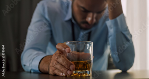 A businessman drinking alcohol to relieve depressed and stressed with problems in his life.