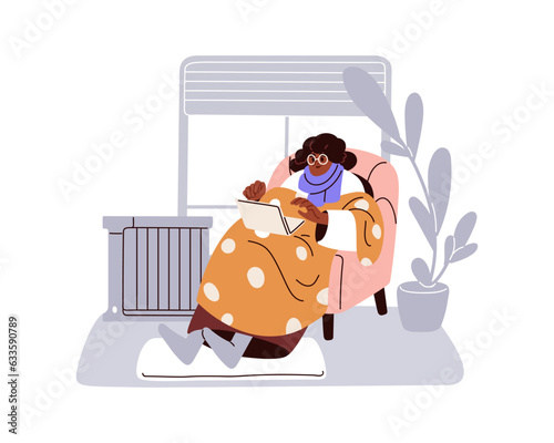 Old black woman at laptop computer, warming with blanket, scarf in cold home....