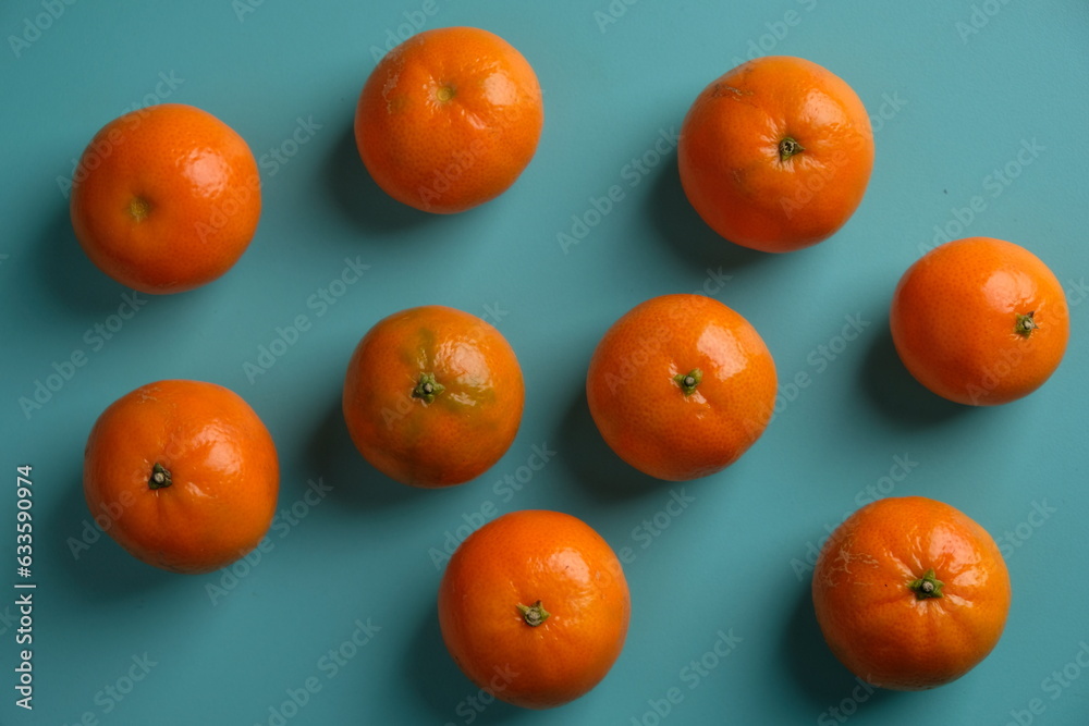 Tangerine or mandarin orange is an orange that can grow in tropical and subtropical areas. Citrus reticulata. Jeruk Mandarin. Served on blue wooden table. 