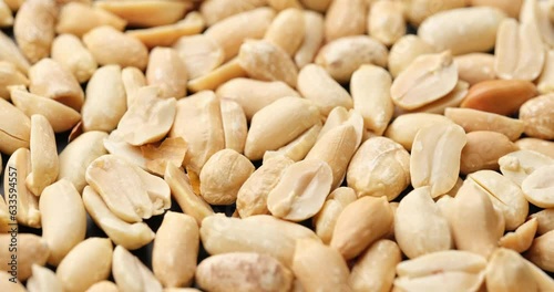 Whole shelled peanut nuts kernels close-up on rotating platform photo