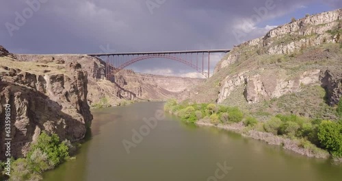 Aerial drone shot over the snake river flying towards the Perrine Memorial Bridge in Twin Falls, Idaho. Flying low and slow over the river. photo