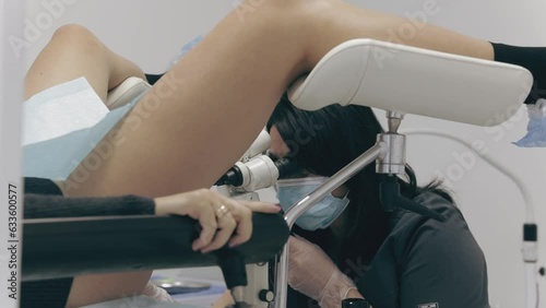 a gynecologist and obstetrician examines a woman. slow motion. Pastel tones colorgrading