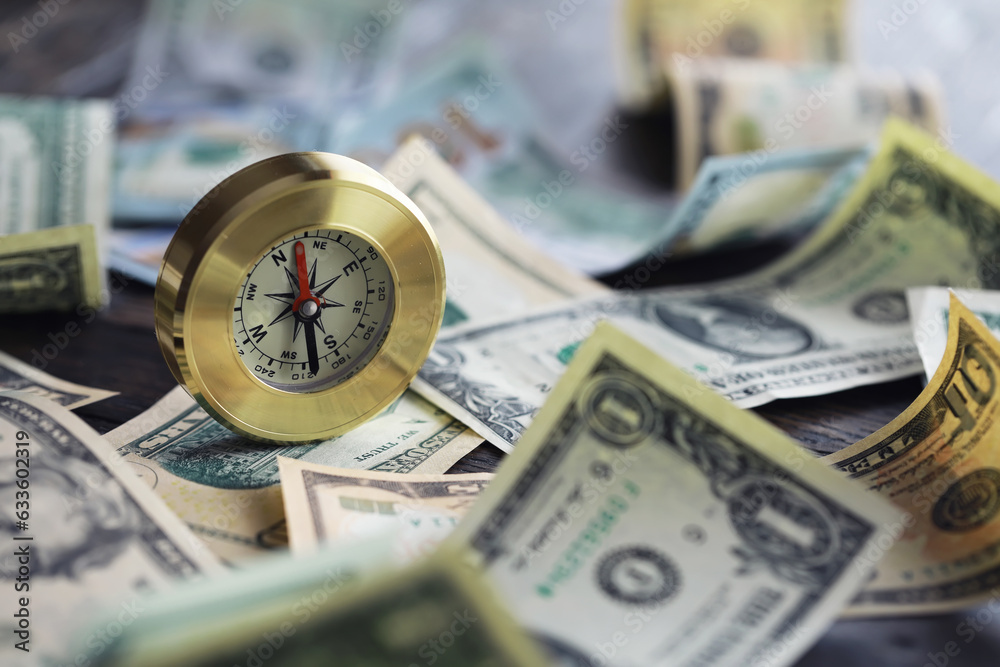 Money bill with golden Compass. Bullets and cartridge cases as a military concept. Close up US Currency and compass. business, financial idea, concept, symbol of crisis, inflation Money bill with golden Compass. Bullets and cartridge cases as a military concept. Close up US Currency and compass. business, financial idea, concept, symbol of crisis, inflation