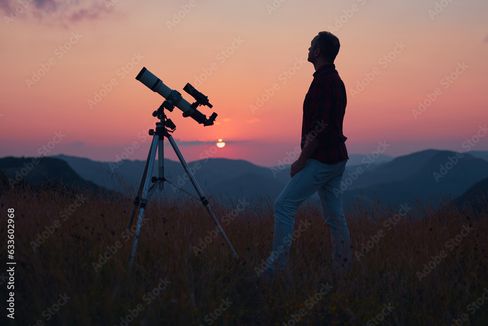 Astronomer looking at the skies with a telescope.