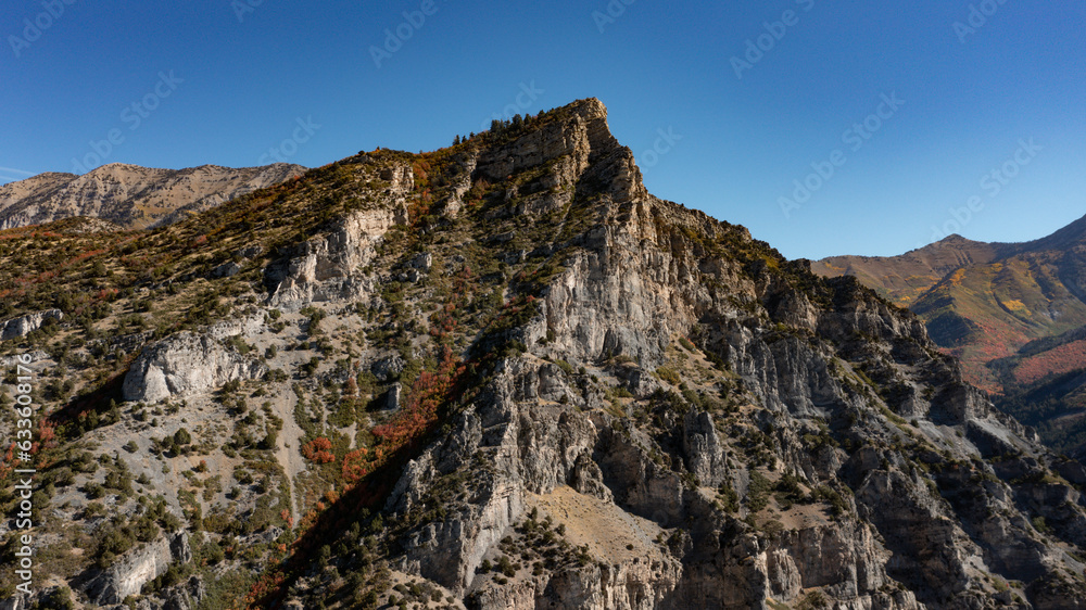Peak of mountain in sunshine with blue sky in fall