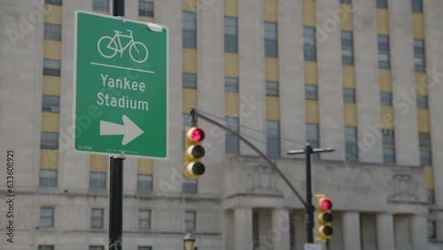 traffic light turns from yellow to red beside Yankee Stadium bike sign in Bronx