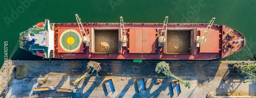 Panoramic view from a drone of a large ship loading grain for export. Water transport