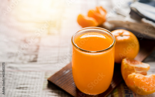 glass of fresh orange juice with fresh fruits on wooden table, high Vitamin C, orange drink