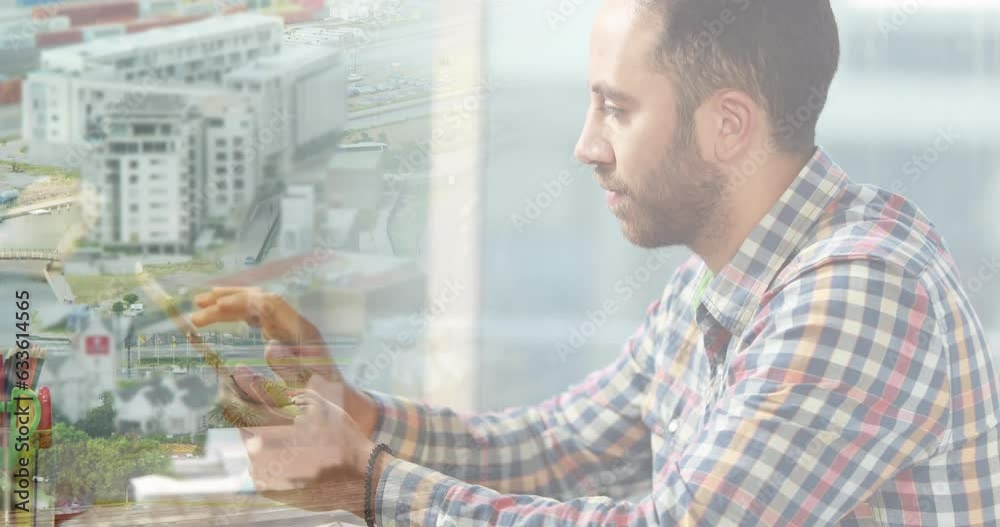 Animation of biracial businessman using tablet over cityscape Animation of biracial businessman using tablet over cityscape