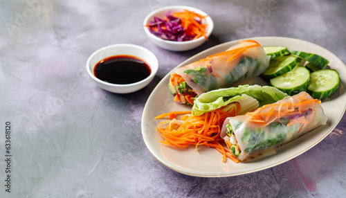 Vegetarian vietnamese spring rolls with spicy sauce, carrot, cucumber, red cabbage and rice noodle. Vegan food. Tasty meal. Copy space