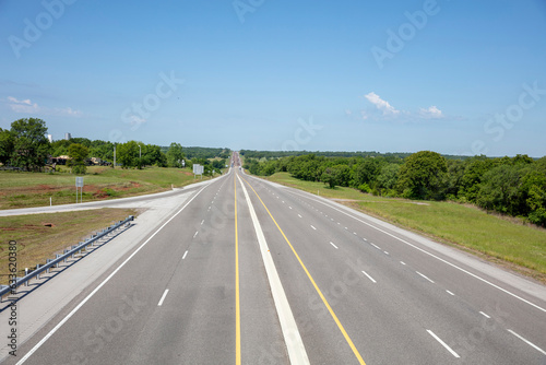 Highway in the American countryside  driveway with lane  sign  nature  blue sky background.