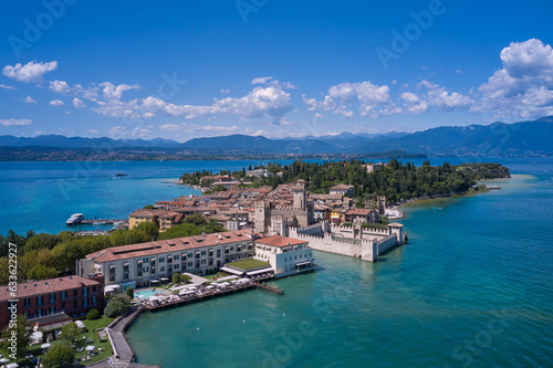 Fototapeta Naklejka Na Ścianę i Meble -  Aerial view to the town of Sirmione, popular travel destination on Lake Garda in Italy. View of the city of Sirmione. Panoramic view of Lake Garda. Sirmione, an ancient village on southern Garda Lake