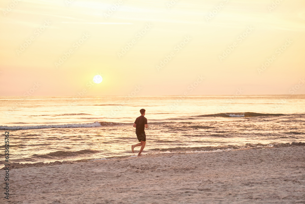 Silhouette of a sportsman running near the ocean shore at sunset. Silhouette of a sportsman running near the ocean shore at sunset.