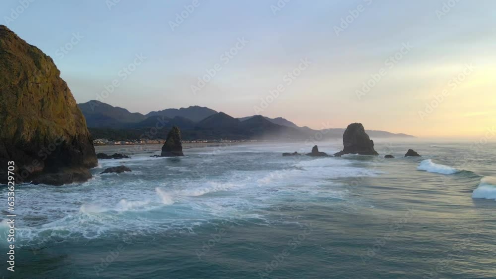 Rocks sea stacks at Canon beach Oregon with waves crashing, aerial view