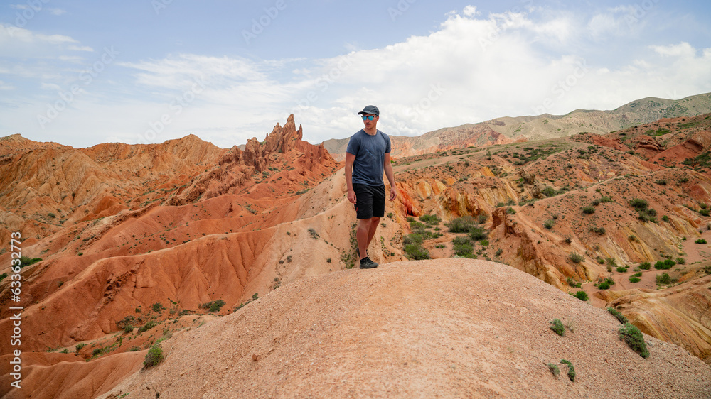 Rear view of man standing at the cliff edge enjoying view from National Canyon. Adventure seeker embraces nature beauty. Tranquil and majestic atmosphere in wilderness