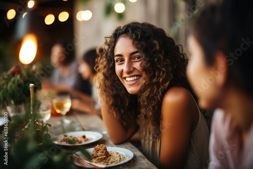 Woman enjoying with friends at outdoor dinner party