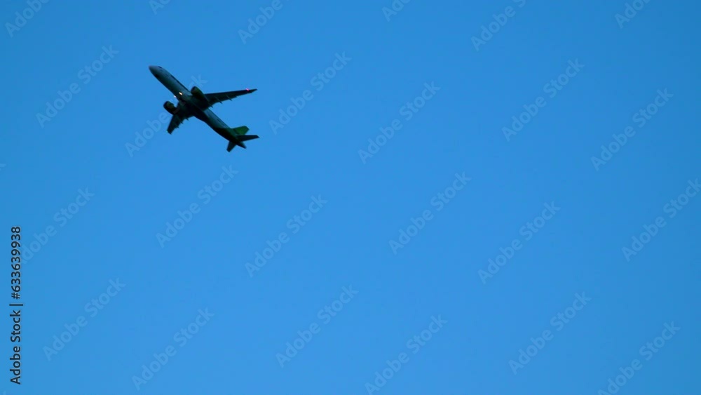 Silhouetted passenger jet airplane taking off against blue sky - low angle view from wire fence of aerodrome
Silhouetted passenger jet airplane taking off against blue sky - low angle view from wire fence of aerodrome