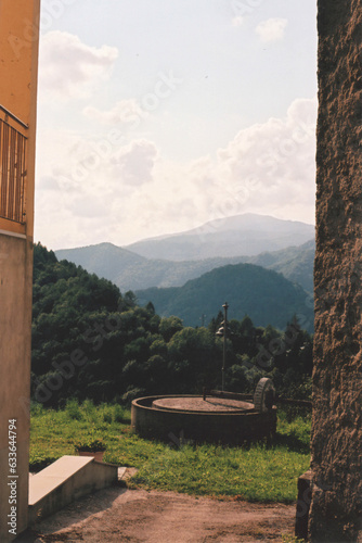 View on an Ancient Millstone in Clabuzzaro Mountain Village During a Sunny Summer Day, Julian Alps. Drenchia, Udine Province, Friuli Venezia Giulia, Italy. Film Photography