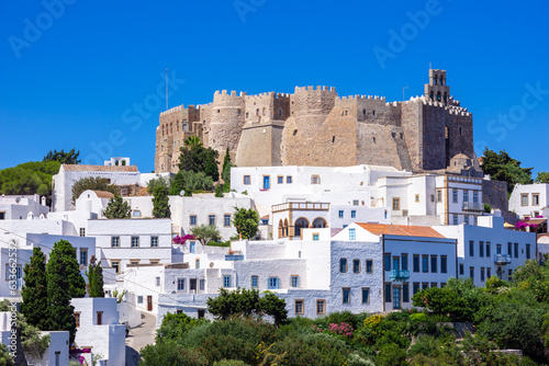 The three windmills of Chora and iconic Monastery of Saint John the Theologian in chora of Patmos island, Dodecanese, Greece photo