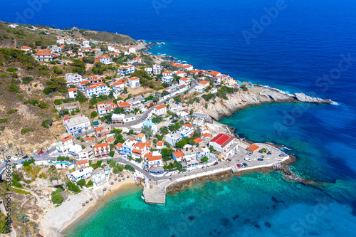 Lovely greek fishing village of Armenistis in a quiet summer morning. Port with local beach in transparent clear water at Ikaria, Greece © gatsi