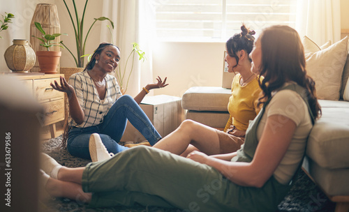Happy, gossip and friends on a floor relax, talking and bond with advice in house together. Conversation, drama and women with diversity in a living room speaking, chilling and enjoy weekend freedom