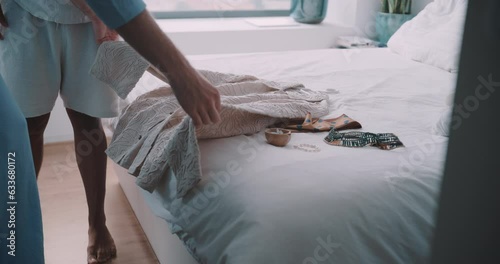 Queer couple setting their elopement outfit on the bed. photo