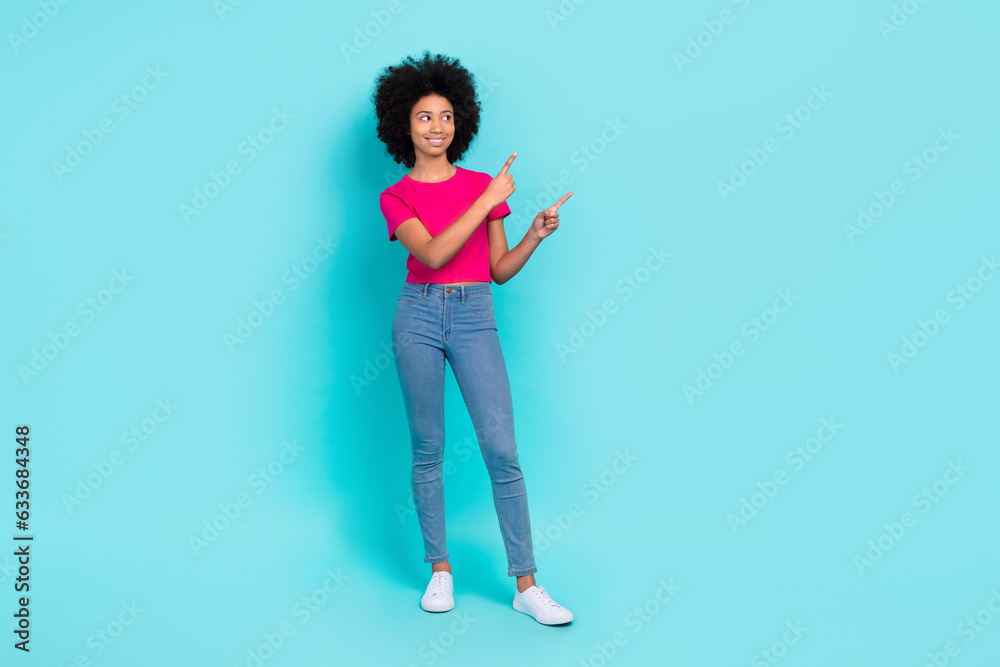 Full size portrait of lovely positive schoolchild look direct fingers empty space novelty blank isolated on turquoise color background Full size portrait of lovely positive schoolchild look direct fingers empty space novelty blank isolated on turquoise color background