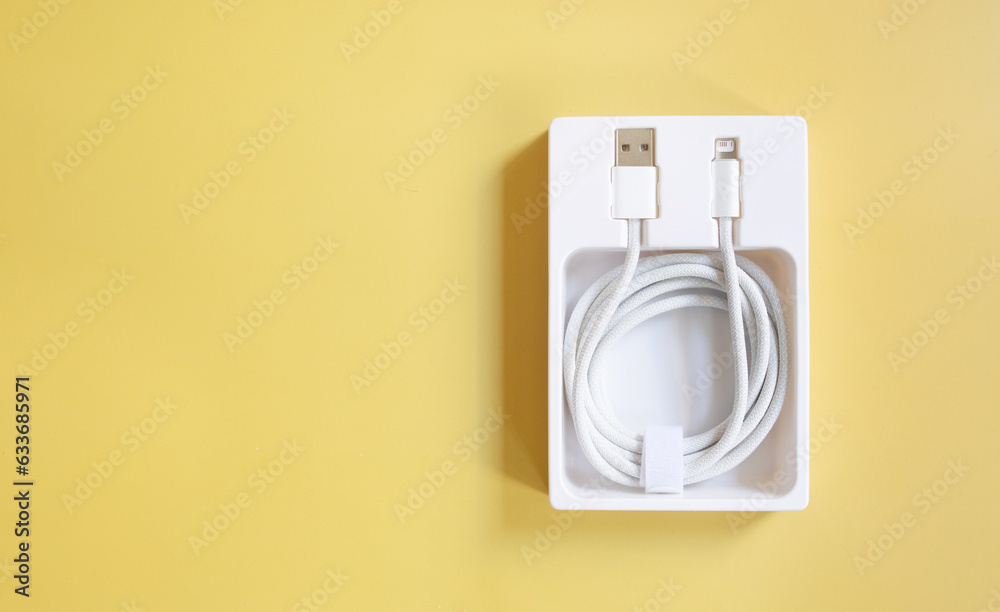 USB cable for smartphone on yellow background. USB cable for smartphone on yellow background.