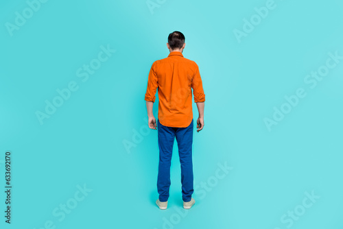 Full size body photo of businessman old age pensioner wear orange formal shirt denim jeans casual apparel isolated on cyan color background