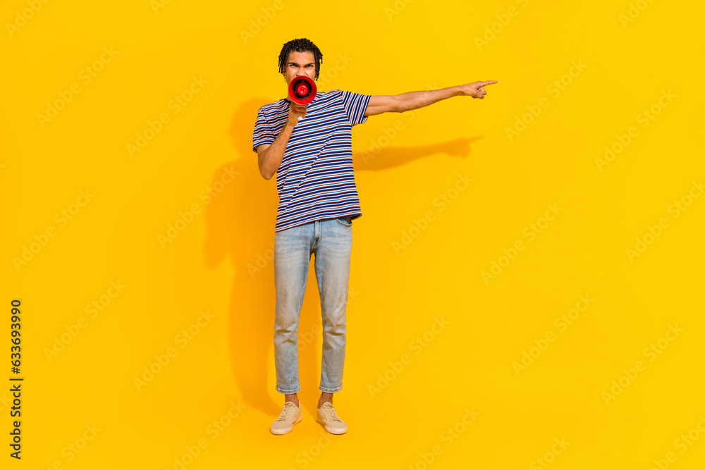 Fototapeta premium Full size photo of negative furious man hold scream loudspeaker direct finger empty space isolated on yellow color background