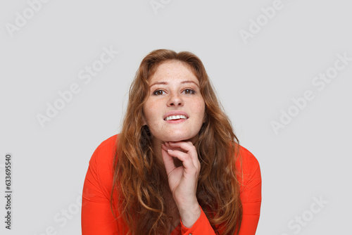 Positive redhead woman looking at camera and smiling on white background