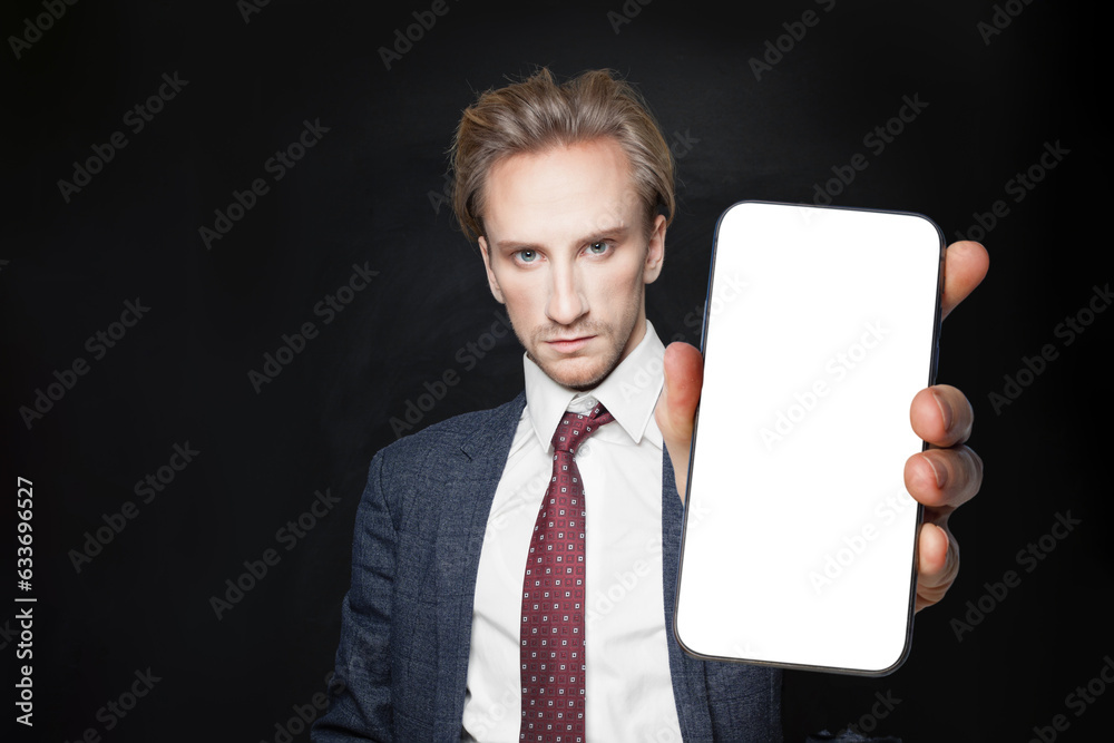 Handsome businessman in suit showing smart phone with blank empty white screen display for new application or mobile website, Mockup banner Handsome businessman in suit showing smart phone with blank empty white screen display for new application or mobile website, Mockup banner