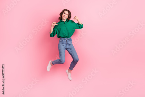 Full size portrait of carefree excited girl jumping point fingers self herself empty space ad isolated on pink color background