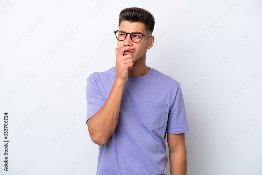 Young caucasian man isolated on white background having doubts and with confuse face expression Young caucasian man isolated on white background having doubts and with confuse face expression