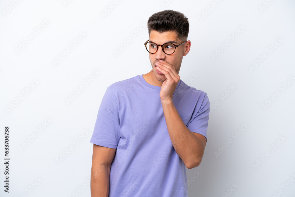 Young caucasian man isolated on white background whispering something with surprise gesture while looking to the side Young caucasian man isolated on white background whispering something with surprise gesture while looking to the side