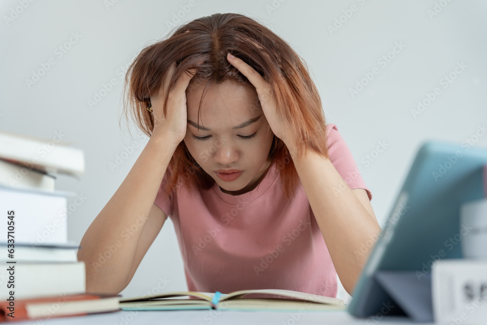 Asian student woman have anxiety because of exams, female prepare for test and learning lessons in the library. stress, despair, haste, misunderstanding reading, discouraged, expectation, knowledge. Asian student woman have anxiety because of exams, female prepare for test and learning lessons in the library. stress, despair, haste, misunderstanding reading, discouraged, expectation, knowledge.