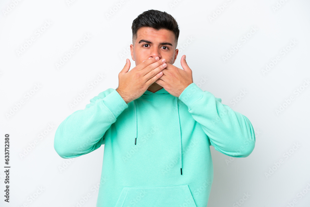 Young caucasian handsome man isolated on white background covering mouth with hands Young caucasian handsome man isolated on white background covering mouth with hands