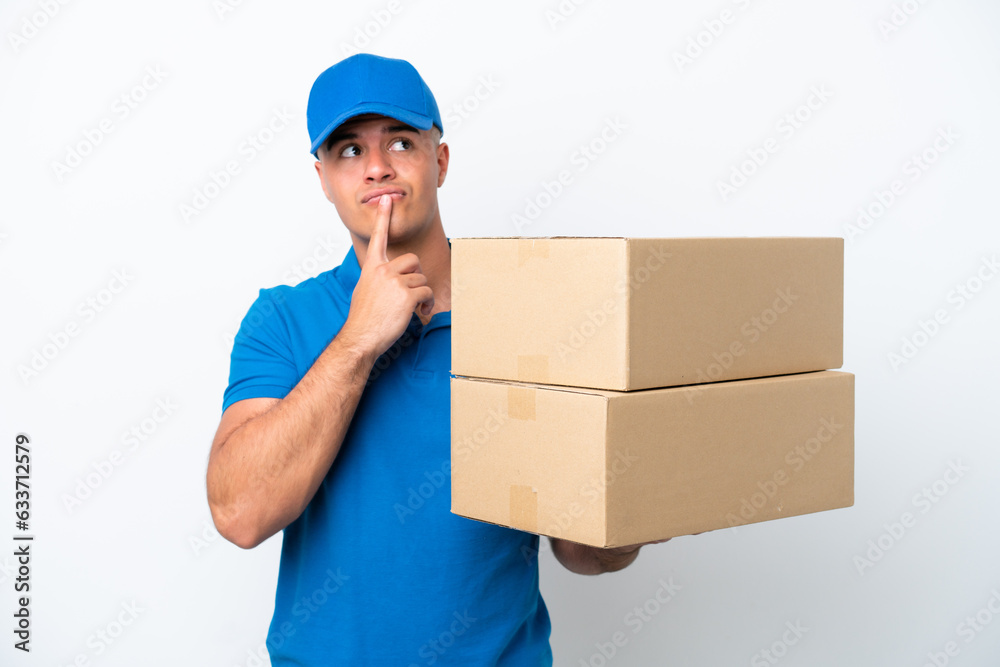 Delivery caucasian man isolated on white background having doubts while looking up Delivery caucasian man isolated on white background having doubts while looking up