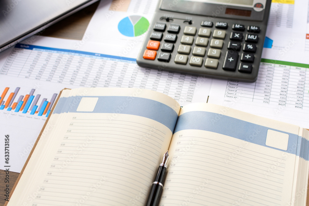 Open leather notebook, drawings, charts, phone, calculator, pencil and laptop on the desk in the office. Business and Finance. Open leather notebook, drawings, charts, phone, calculator, pencil and laptop on the desk in the office. Business and Finance.