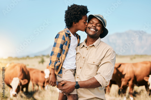 Farm, cows and child kiss father in countryside for ecology, adventure and agriculture. Family, sustainable farming and African dad happy with boy embrace for bonding, relax and learning with animals
