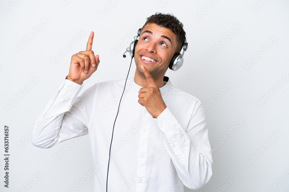 Telemarketer Brazilian man working with a headset isolated on white background pointing with the index finger a great idea Telemarketer Brazilian man working with a headset isolated on white background pointing with the index finger a great idea