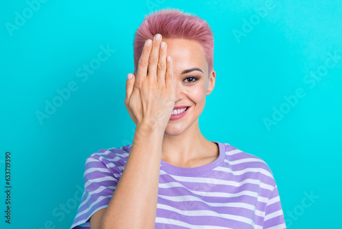 Portrait of cute positive girl toothy smile arm palm covering one eye isolated on vibrant turquoise color background
