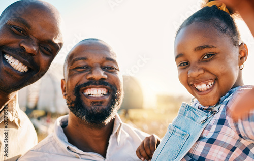 Farm, selfie and portrait of gay parents with girl in countryside for holiday, adventure and vacation. Black family, sustainable farming and lgbtq fathers with kid for bonding, relax or fun in nature © Ramba/peopleimages.com