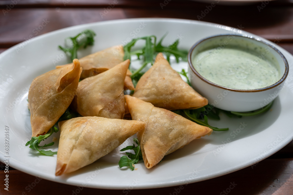 Traditional Middle East snack fried stuffed samosa pie with vegetables served with mint sauce Traditional Middle East snack fried stuffed samosa pie with vegetables served with mint sauce
