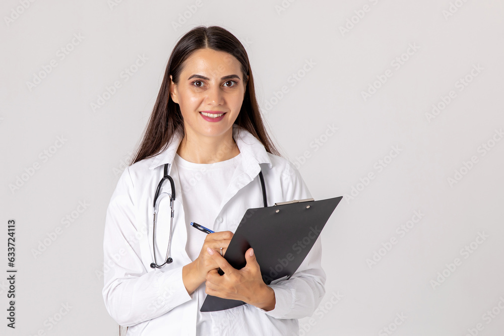 medicine, profession and healthcare concept - happy smiling female doctor in white coat with clipboard and pen on white background medicine, profession and healthcare concept - happy smiling female doctor in white coat with clipboard and pen on white background