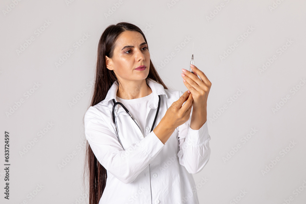 Smiling female doctor with stethoscope holding syringe on white background. Medicine, immunization and health care. vaccination concept. High quality photo Smiling female doctor with stethoscope holding syringe on white background. Medicine, immunization and health care. vaccination concept. High quality photo